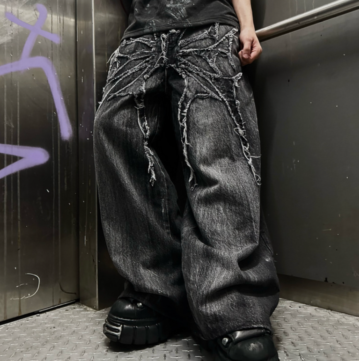 Embroidered spider graphic jeans