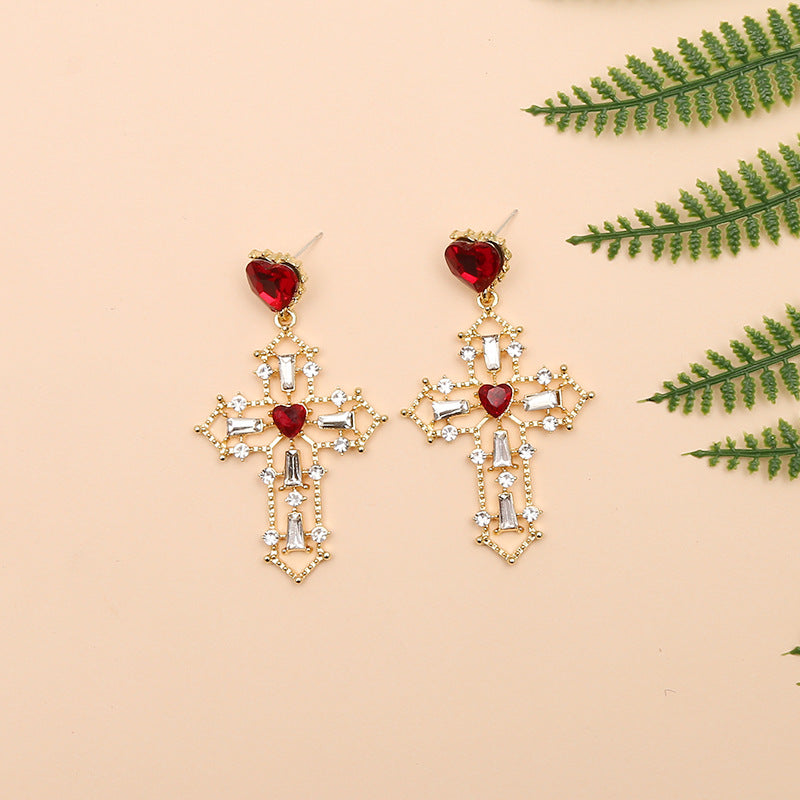 Gold cross earrings with heart design