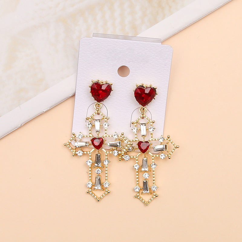 Gold cross earrings with heart design