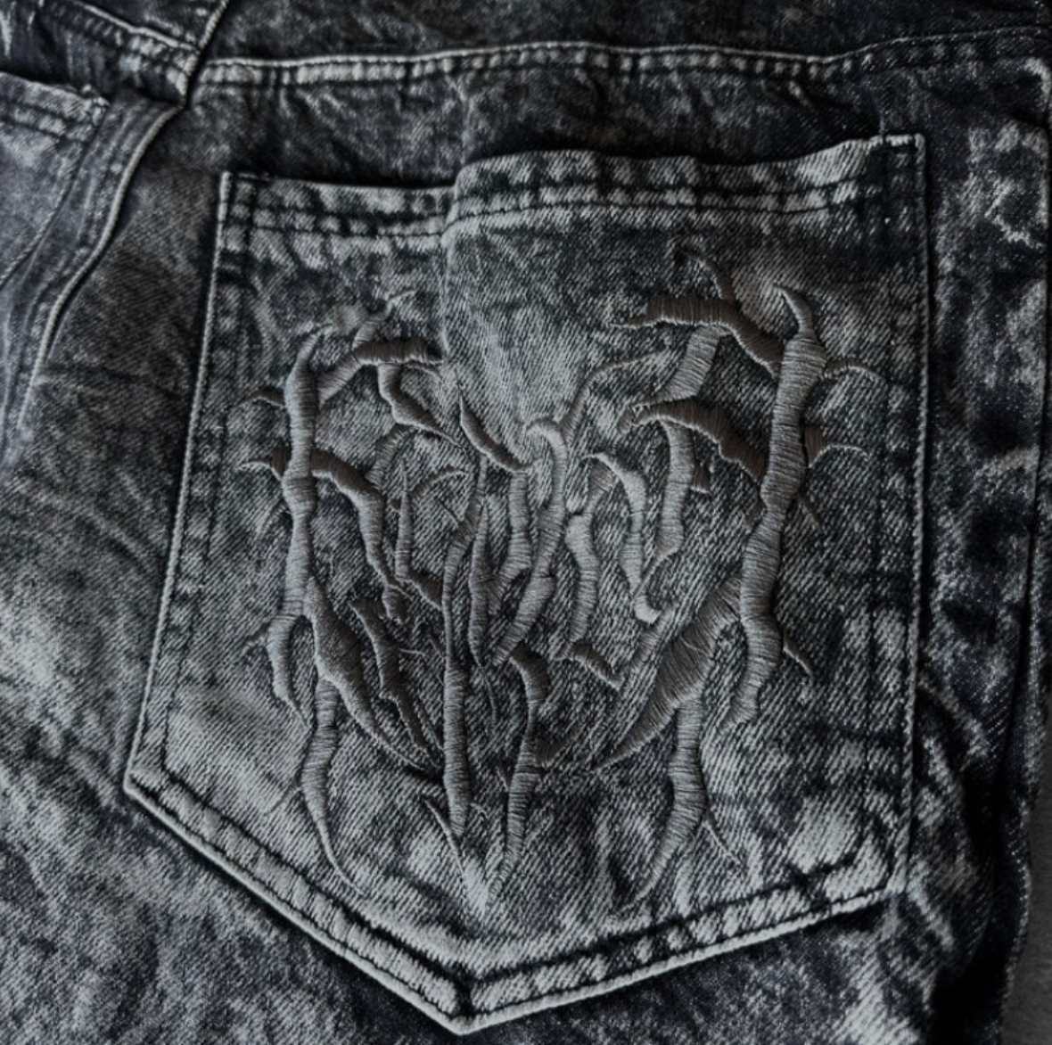 Embroidered spider graphic jeans