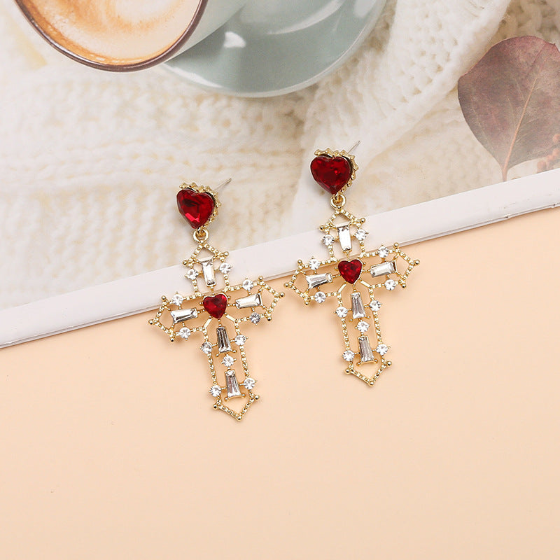 Gold cross earrings with heart design