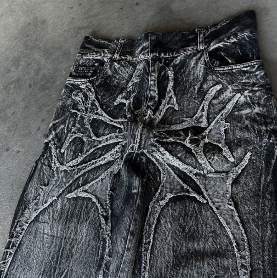 Embroidered spider graphic jeans